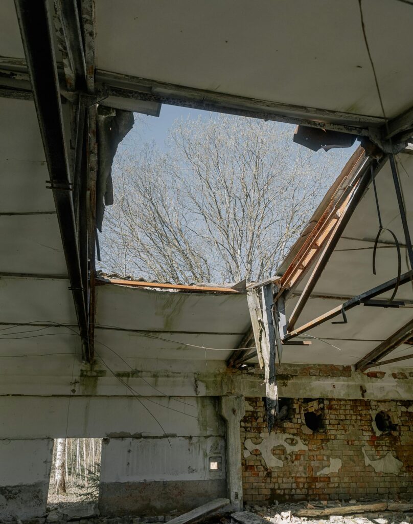 An abandoned building with a broken roof showcasing urban decay.